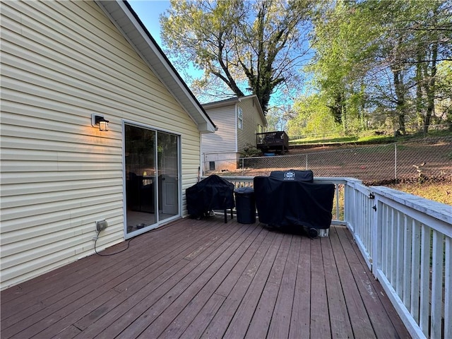 deck featuring fence and area for grilling