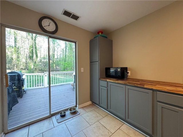 doorway featuring light tile patterned flooring and visible vents