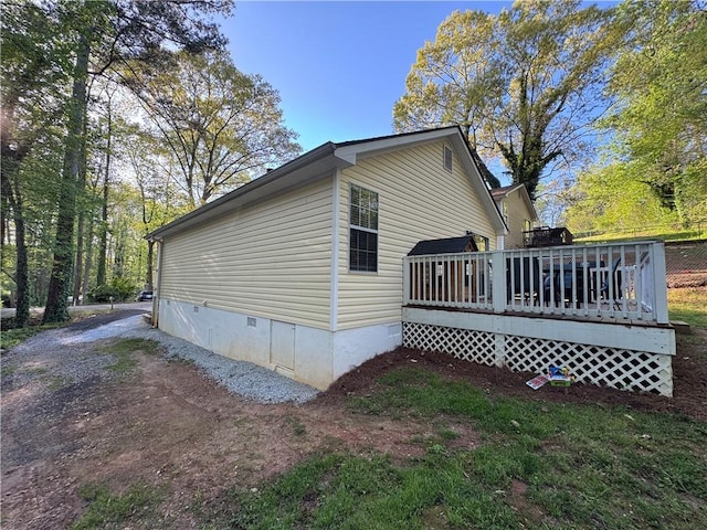 view of home's exterior featuring a wooden deck and crawl space