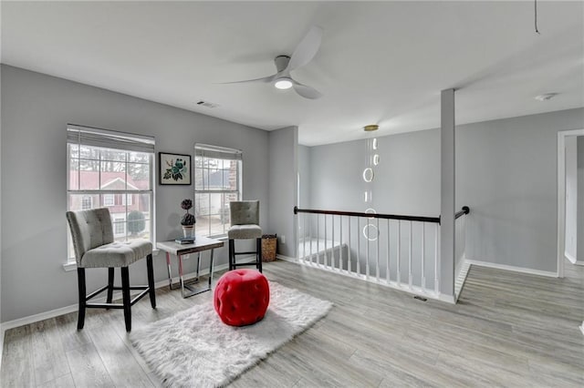 sitting room featuring ceiling fan and light hardwood / wood-style flooring