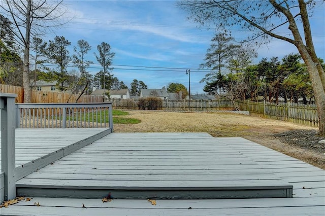 wooden deck featuring a lawn