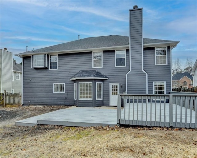 back of property with a wooden deck