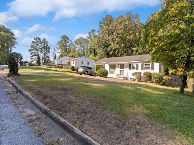 ranch-style home with a porch and a front lawn