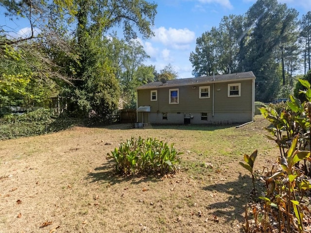 rear view of property with a lawn