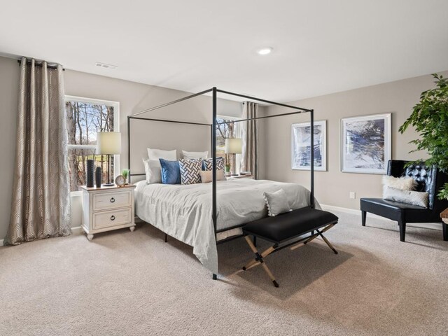 bedroom featuring light colored carpet