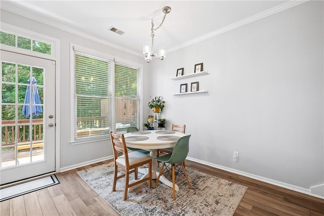 5710 Waters Edge Trl, Roswell, GA 30075 - dining space featuring a chandelier, crown molding, and wood finished floors