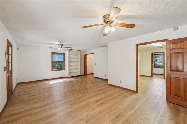 2110 Waterloo Cir, Lawrenceville, GA 30043 - unfurnished room featuring built in features, light wood-type flooring, a ceiling fan, and a textured ceiling