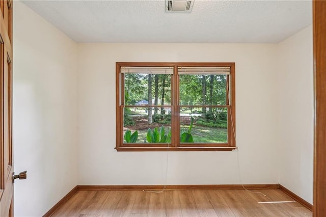 2110 Waterloo Cir, Lawrenceville, GA 30043 - spare room featuring light wood finished floors and a textured ceiling