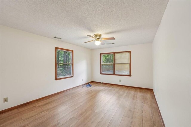 2110 Waterloo Cir, Lawrenceville, GA 30043 - empty room with ceiling fan, a textured ceiling, and light wood finished floors