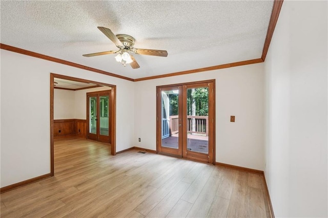 2110 Waterloo Cir, Lawrenceville, GA 30043 - empty room with french doors, light wood finished floors, ornamental molding, a textured ceiling, and ceiling fan