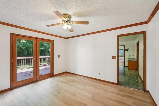 2110 Waterloo Cir, Lawrenceville, GA 30043 - unfurnished room featuring wood finished floors, french doors, a ceiling fan, a textured ceiling, and ornamental molding