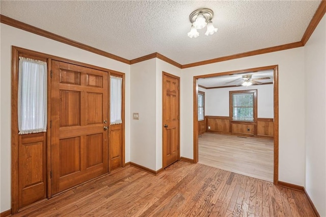 2110 Waterloo Cir, Lawrenceville, GA 30043 - entryway with light wood-type flooring, a textured ceiling, wainscoting, and crown molding