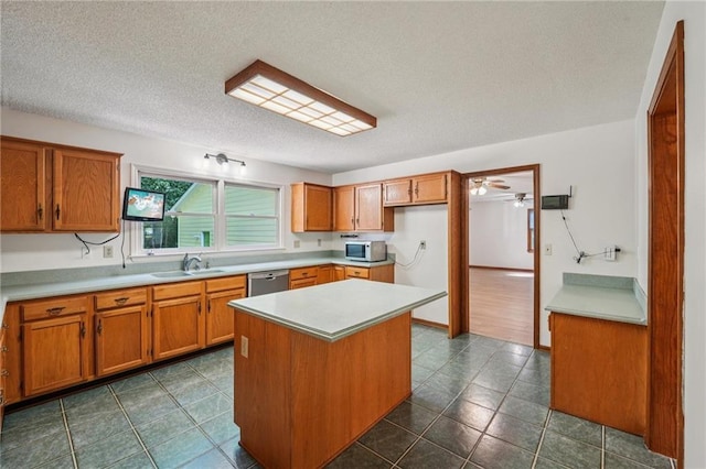 2110 Waterloo Cir, Lawrenceville, GA 30043 - kitchen featuring white microwave, brown cabinets, stainless steel dishwasher, a textured ceiling, and light countertops