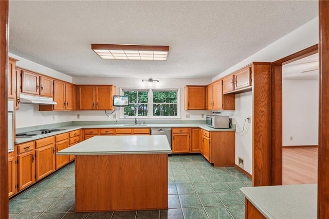 2110 Waterloo Cir, Lawrenceville, GA 30043 - kitchen featuring black electric stovetop, under cabinet range hood, stainless steel dishwasher, light countertops, and brown cabinets