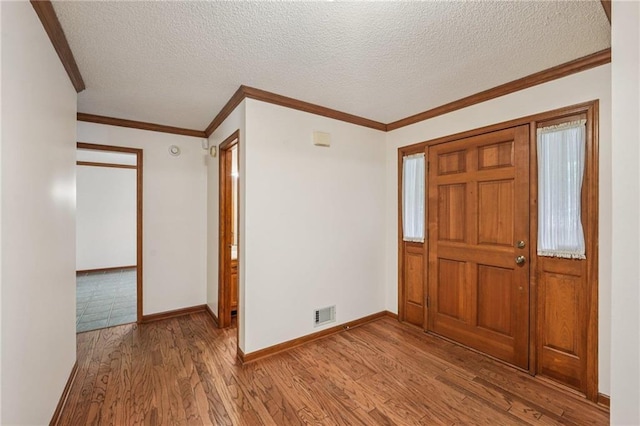 2110 Waterloo Cir, Lawrenceville, GA 30043 - foyer featuring wood finished floors, a textured ceiling, and crown molding