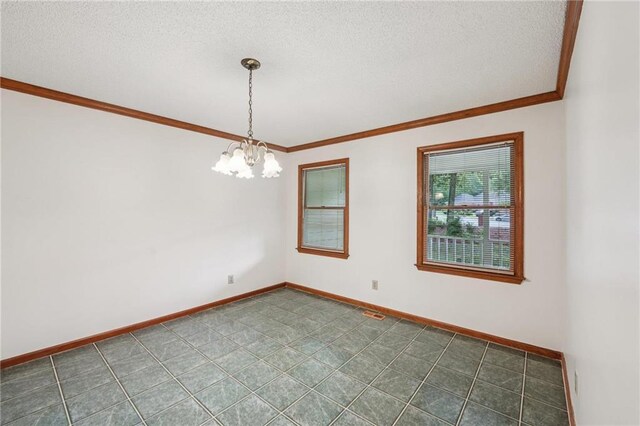 2110 Waterloo Cir, Lawrenceville, GA 30043 - spare room featuring ornamental molding, a chandelier, and a textured ceiling