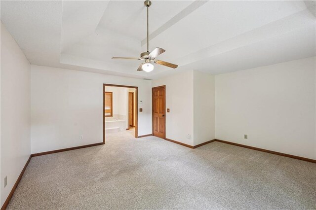 2110 Waterloo Cir, Lawrenceville, GA 30043 - spare room featuring light colored carpet, ceiling fan, and a tray ceiling
