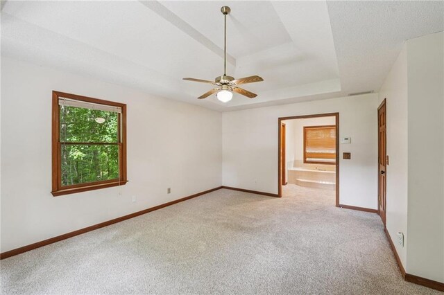 2110 Waterloo Cir, Lawrenceville, GA 30043 - empty room featuring light colored carpet, a tray ceiling, and ceiling fan