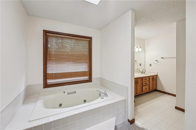 2110 Waterloo Cir, Lawrenceville, GA 30043 - bathroom with vanity, a tub with jets, tile patterned flooring, and a textured ceiling