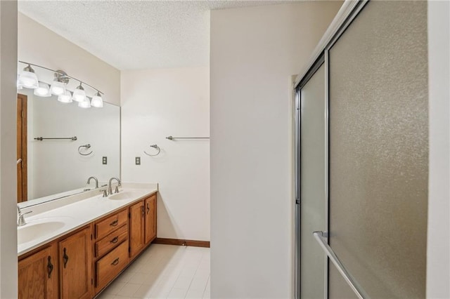 2110 Waterloo Cir, Lawrenceville, GA 30043 - bathroom with double vanity, a shower with shower door, a textured ceiling, and tile patterned flooring