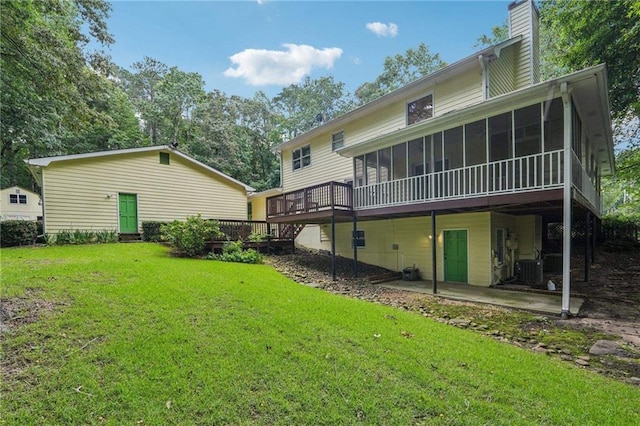 2110 Waterloo Cir, Lawrenceville, GA 30043 - rear view of house featuring a sunroom, a chimney, a wooden deck, a yard, and a patio area