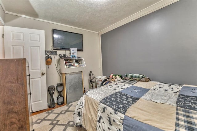 bedroom featuring ornamental molding and a textured ceiling