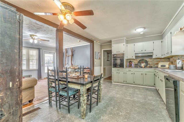 kitchen with sink, white cabinets, decorative backsplash, black appliances, and crown molding