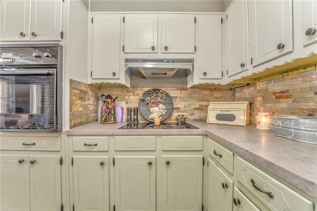 kitchen featuring white cabinetry, backsplash, and black appliances