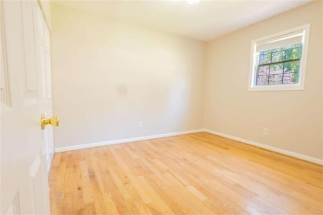 unfurnished room featuring light wood-style floors and baseboards