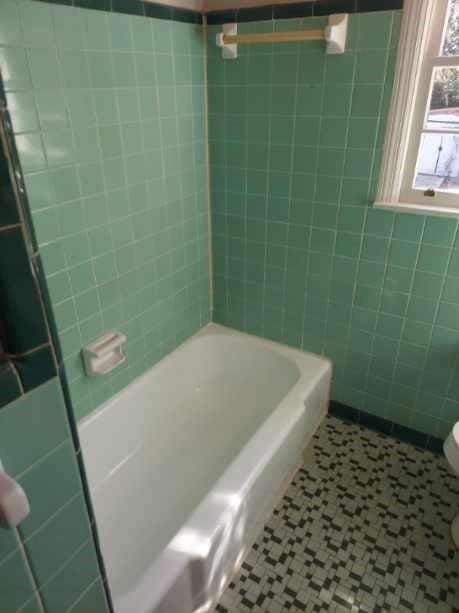 bathroom with tile walls, tile patterned flooring, bathing tub / shower combination, and toilet