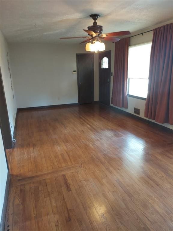 unfurnished room featuring hardwood / wood-style flooring and ceiling fan