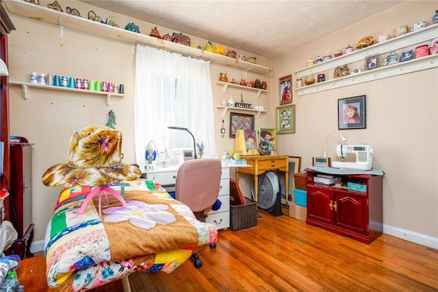 bedroom with hardwood / wood-style floors and a textured ceiling