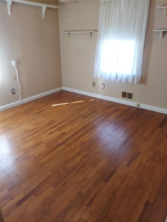 spare room featuring wood-type flooring