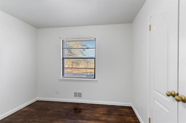 empty room featuring dark hardwood / wood-style flooring