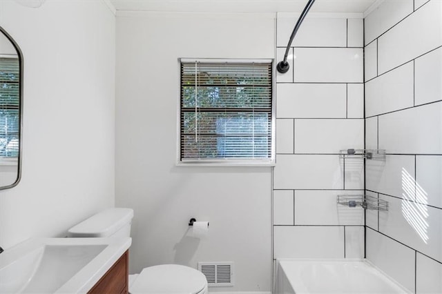 full bathroom featuring tiled shower / bath, vanity, and toilet