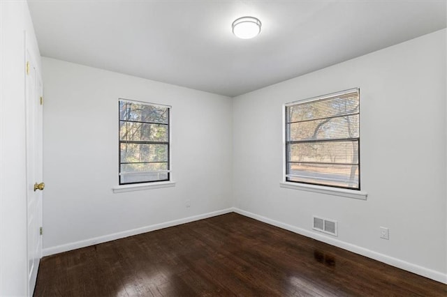 unfurnished room with hardwood / wood-style flooring