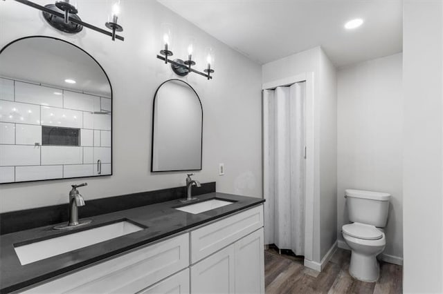 bathroom featuring hardwood / wood-style flooring, vanity, and toilet