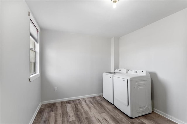 washroom featuring light wood-type flooring and washer and clothes dryer