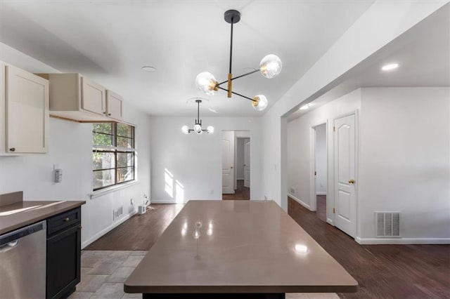 kitchen with dishwasher, an inviting chandelier, hanging light fixtures, dark hardwood / wood-style floors, and a kitchen island