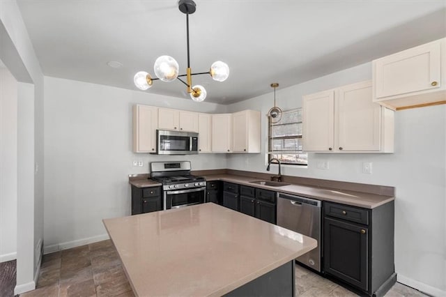 kitchen with white cabinetry, sink, hanging light fixtures, a center island, and stainless steel appliances