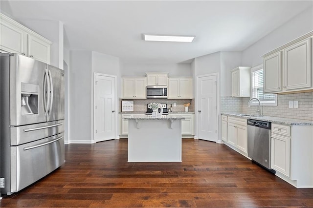 306 Springwater Way, Bremen, GA 30110 - kitchen featuring appliances with stainless steel finishes, dark wood-style flooring, backsplash, light stone counters, and white cabinets