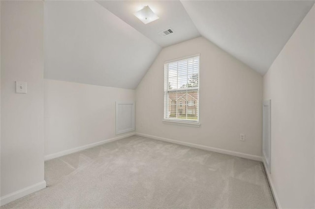 additional living space with lofted ceiling, carpet, and baseboards