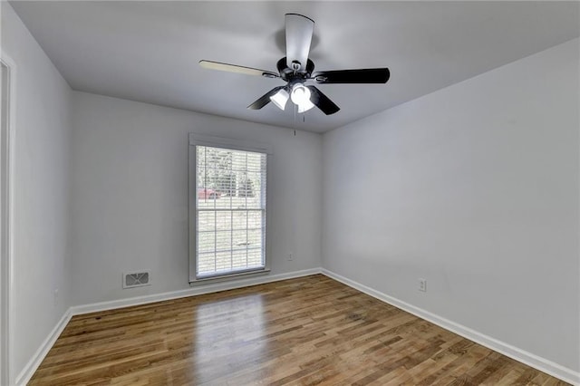 empty room featuring wood-type flooring and ceiling fan