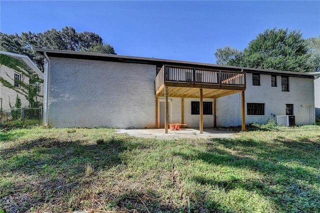 back of property with central AC, a yard, and a patio