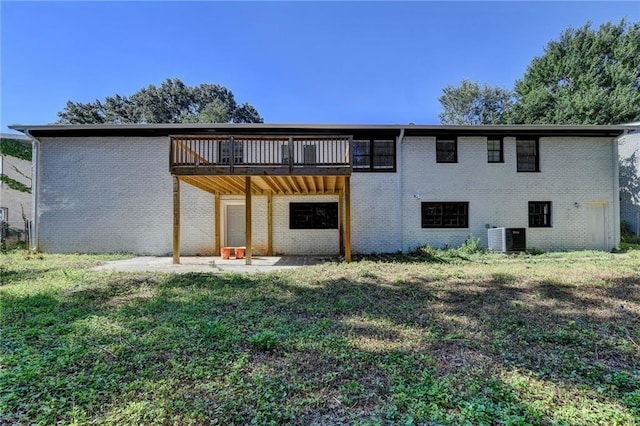 back of house with a lawn and central AC unit