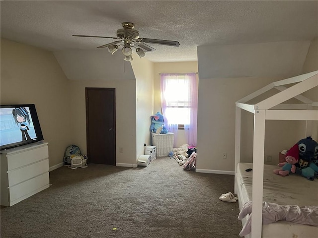 unfurnished bedroom featuring baseboards, ceiling fan, vaulted ceiling, carpet flooring, and a textured ceiling