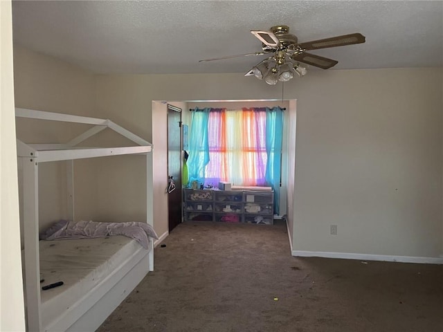 carpeted bedroom featuring a ceiling fan, baseboards, and a textured ceiling