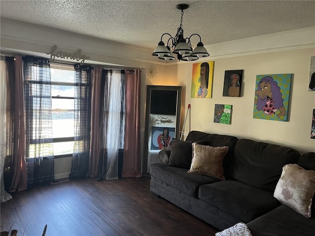 living area with a notable chandelier, crown molding, and wood finished floors