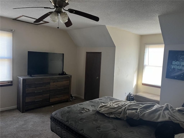 carpeted bedroom featuring lofted ceiling, a ceiling fan, baseboards, and a textured ceiling