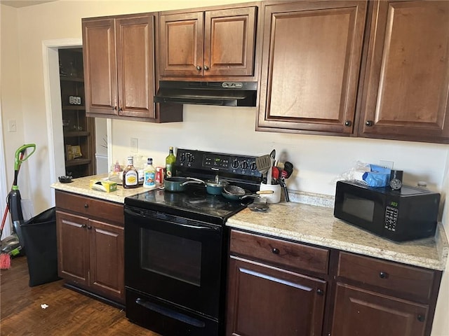 kitchen with black appliances, light stone counters, dark wood-type flooring, and under cabinet range hood